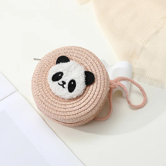Small Round pink pouch with a panda face charm on a light background