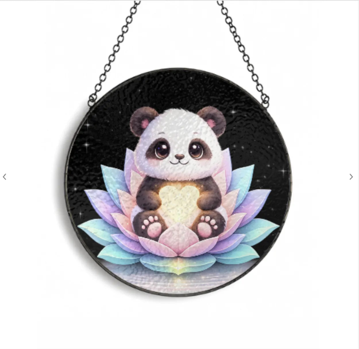 Circular pendant with a panda and lotus design on a black background